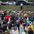 Jeanelle Austin and others hold candles at Say Their Names Cemetery on the 5th anniversary of George Floyd's murder.
