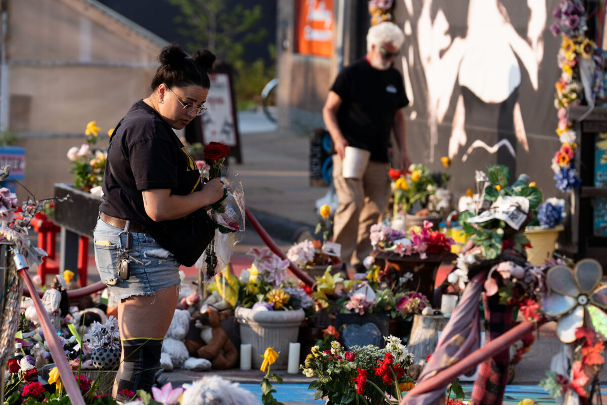 Laying flowers at George Floyd Memorial