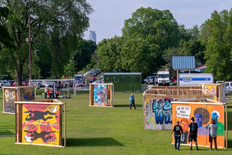 Memorialize The Movement 5th Anniversary 4 Boards from the Minneapolis Uprising at Phelps Park on the 5th anniversary of George Floyd's murder. Memorialize The Movement is an organization that has worked to preserve these boards as historical artifacts.
