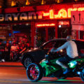 Patrons sit outside the Bryant Lake Bowl on Lake Street on a summer night.