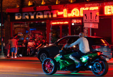 Patrons sit outside the Bryant Lake Bowl on Lake Street on a summer night.