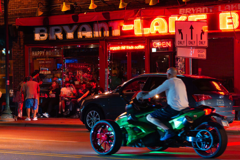 Bryant Lake Bowl Neon Sign, Lake Street, Minneapolis Night 1 The vibrant neon sign of Bryant Lake Bowl illuminates Lake Street in Minneapolis at night. Established in 1936, this historic bowling alley and theater has served as a community gathering place and entertainment venue for decades. Located in a bustling commercial corridor, Bryant Lake Bowl contributes to the lively streetscape of Lake Street, a significant artery known for its diverse businesses and cultural activity. Patrons gather outside on a summer evening, reflecting the venue's enduring role in the city's social fabric.