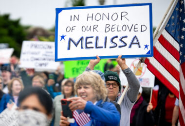 Protester at the No Kings protest in St. Paul, Minnesota on June 14th, 2025. Holding up a sign that reads "In Honor Of Our Beloved Melissa". Referring to Minnesota lawmaker Melissa Hortman who was assassinated hours earlier.