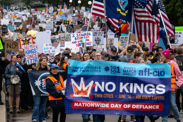 Indivisible Twin Cities No Kings Banner 2 Indivisible Twin Cities No Kings banner during a march in June.
Despite warnings from the law enforcement not to attend today’s No Kings rally after this mornings shootings of Minnesota lawmakers with the killer on the lose, the No Kings Rally is happening at the Minnesota State Capitol in St. Paul.