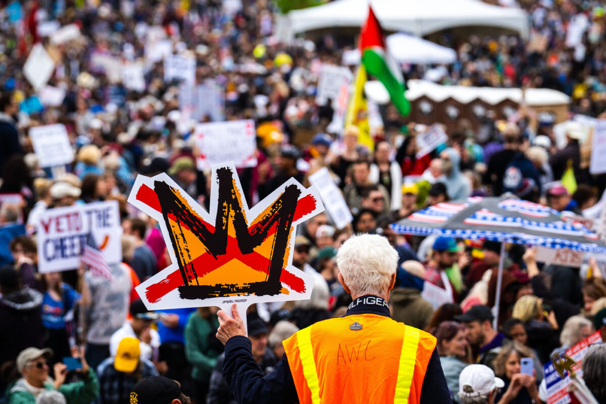 Man holds up No Kings sign in St Paul