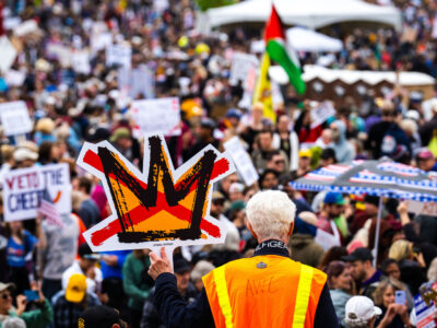 Man holds up No Kings sign in St Paul