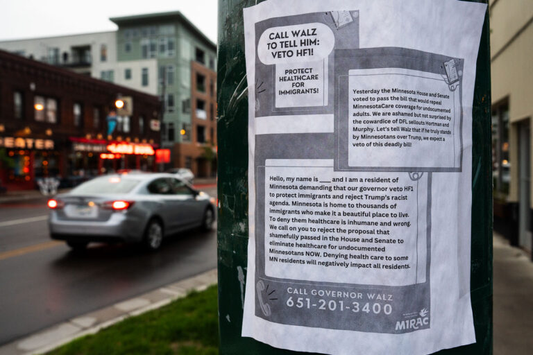 Protect healthcare for immigrants flyer 1 A flyer urging people to call Minnesota Governor Tim Walz and demand he veto HF1, a bill repealing MinnesotaCare coverage for undocumented adults. The flyer has bold text reading “CALL WALZ TO TELL HIM: VETO HF1! PROTECT HEALTHCARE FOR IMMIGRANTS!” It states that the Minnesota House and Senate passed the bill and criticizes lawmakers for supporting it. The flyer provides a sample script for callers, emphasizing that denying healthcare to immigrants is inhumane and harmful to all residents. At the bottom, it lists the governor’s phone number: 651-201-3400, and includes the logo of MIRAC (Minnesota Immigrant Rights Action Committee).