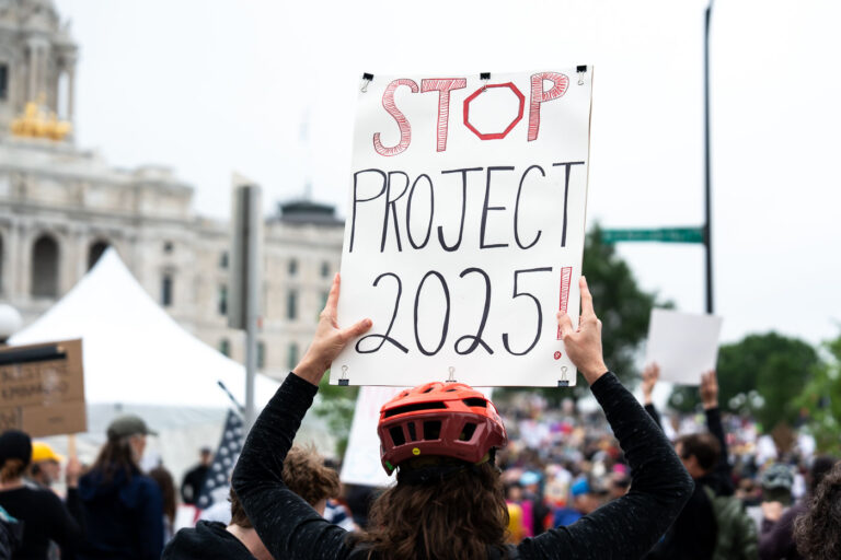 Stop Project 2025! No Kings Protest 3 Protester with a Stop 2025! protest sign at a No Kings rally in June.
Despite warnings from the law enforcement not to attend today’s No Kings rally after this mornings shootings of Minnesota lawmakers with the killer on the lose, the No Kings Rally is happening at the Minnesota State Capitol in St. Paul.