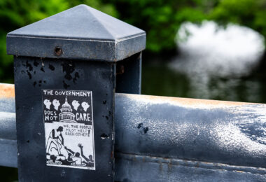 Sticker reading "The Government does not care. We the people must help each other!"