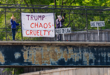 Protesters with banners during rush hour tonight over I-394. They read: Trump: Chaos +Cruelty, Rule Of Law, Due Process