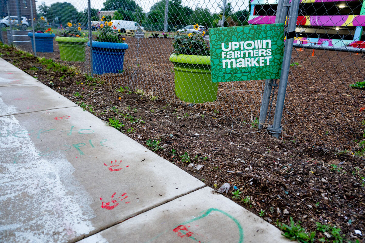 Uptown Farmers Market Yard Sign in Uptown Minneapolis. Hand prints left over from protests following the killing of Winston Smith and Deona Marie in 2021.