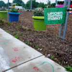 Uptown Farmers Market Yard Sign in Uptown Minneapolis. Hand prints left over from protests following the killing of Winston Smith and Deona Marie in 2021.
