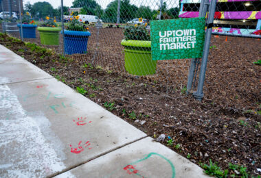 Uptown Farmers Market Yard Sign in Uptown Minneapolis. Hand prints left over from protests following the killing of Winston Smith and Deona Marie in 2021.