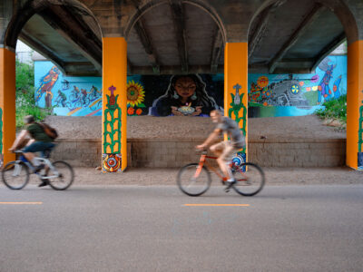 Bikers Pass Minneapolis Midtown Greenway Uprising Mural