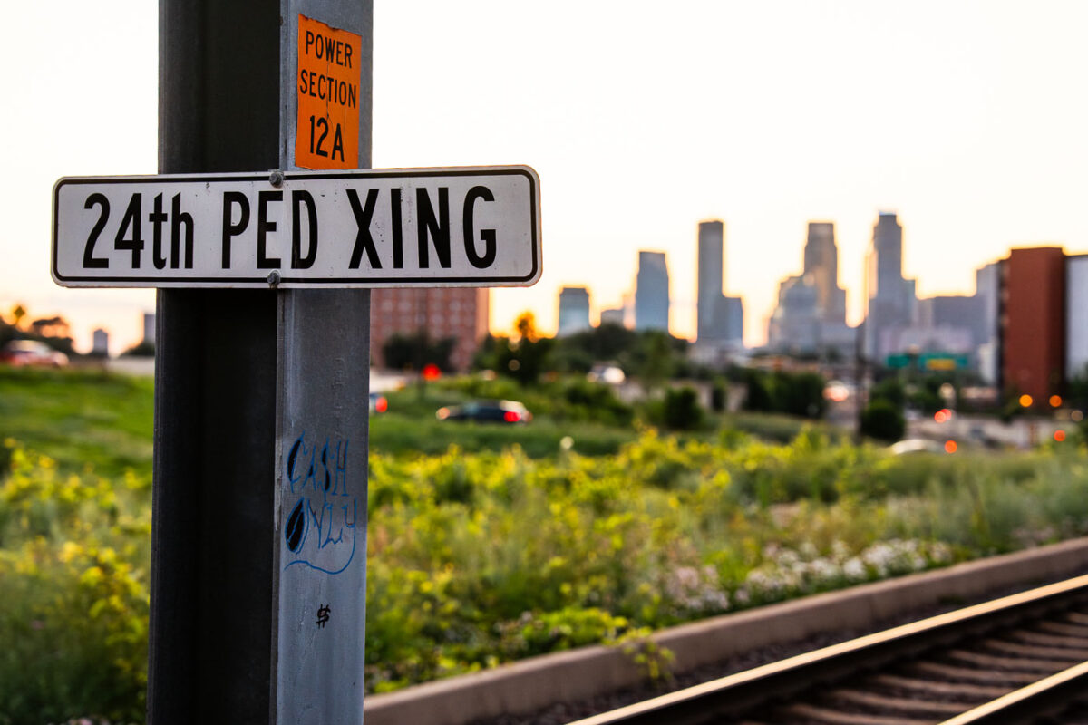 A 24th PED XING sign in South Minneapolis. The sign is on the Metro Transit light rail tracks near Downtown.