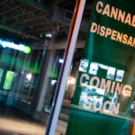 A Cannabis Dispensary Coming Soon banner in the window of the long vacant Jon English Salon, at 1439 Lake Street in Uptown Minneapolis.