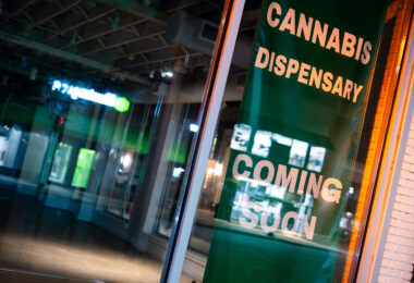 A Cannabis Dispensary Coming Soon banner in the window of the long vacant Jon English Salon, at 1439 Lake Street in Uptown Minneapolis.