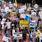 Good Trouble protest signs in Downtown Minneapolis 2 Protesters in Downtown Minneapolis as part of nationwide “Good trouble lives on” protests.Organizers say “Good Trouble Lives On is a national day of action to respond to the attacks on our civil and human rights by the Trump administration. Together, we’ll remind them that in America, the power lies with the people.”After gathering at the Hennepin County Government Center listening to speakers such as Toussaint Morrison, Nekima Levy Armstrong, and Lieutenant Governor Peggy Flanagan they marched through Downtown Minneapolis.