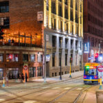 A Metro Transit light rail train goes down N 5th Street past Cowboy Jack's in downtown Minneapolis.
