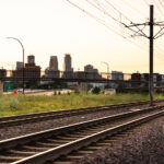 A Metro Transit train heading out of Downtown Minneapolis during a July 2025 sunset.
