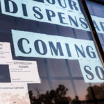"Our Dispensary Coming Soon" in storefront windows on Hennepin Avenue in Uptown Minneapolis.