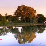 2 paddle boarders meet during sunset on Lake of the Isles in South Minneapolis.