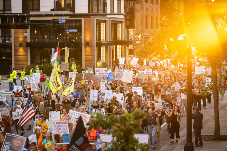 Sunset and Good Trouble Protesters in Downtown Minneapolis 3 Protesters in Downtown Minneapolis as part of nationwide “Good trouble lives on” protests.Organizers say “Good Trouble Lives On is a national day of action to respond to the attacks on our civil and human rights by the Trump administration. Together, we’ll remind them that in America, the power lies with the people.”After gathering at the Hennepin County Government Center listening to speakers such as Toussaint Morrison, Nekima Levy Armstrong, and Lieutenant Governor Peggy Flanagan they marched through Downtown Minneapolis.