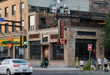 People crossing the street at Lagoon Ave and Hennepin Ave in Uptown Minneapolis.