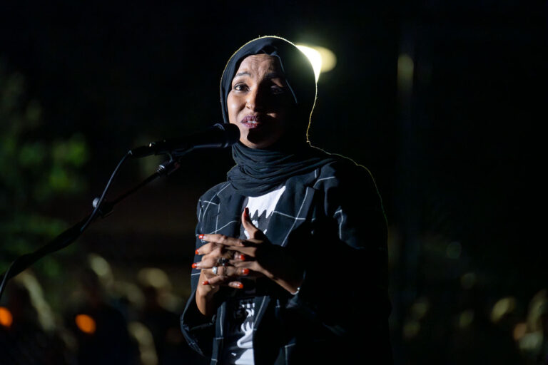 MN US Representative Ilhan Omar at vigil 1 The Minneapolis community gathered at Lynnhurst Park last night for a vigil following the mass shooting at Annunciation School and Church earlier in the morning. 2 children were killed and 17 others injured. The crowd heard from speakers ranging from the Minnesota Attorney General, Minneapolis Mayor and City Council Members, and Congresswomen.