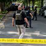 Police at Annunciation Catholic School and Church in Minneapolis on August 27, 2025 following a mass shooting that killed 2 children and injured 17 others, 14 of them children.