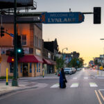 Uptown Pizza at Lake Street and Grand Ave 2 A woman walks across Lake Street outside of Uptown Pizza during a mid August sunset.