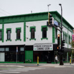 A banner reading "Cannabis Dispensery[sic] Coming Soon" at the long time Juut hair salon that's been vacant for a few years.