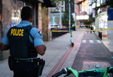 Minneapolis police officer stands at the scene of a double shooting in Downtown Minneapolis on September 26, 2025.