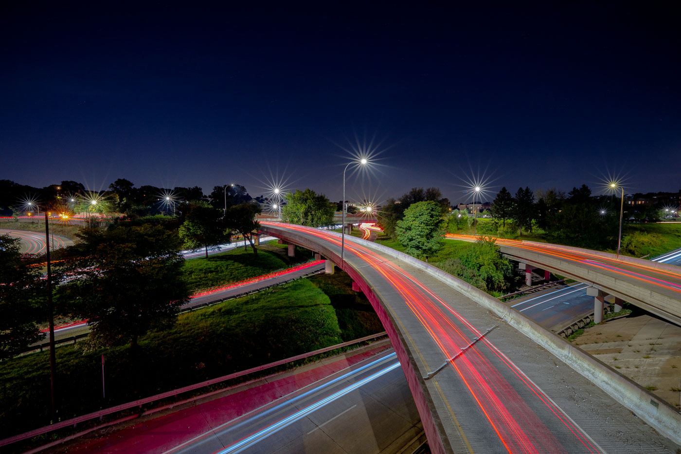 Night photo of car light trails on multiple freeways