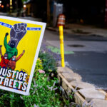 A "No Justice No Streets" yard sign in the middle of Chicago Avenue and East 38th Street at George Floyd Square. The area continues to be a place of protest since the May 2020 murder of George Floyd.
