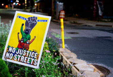 A "No Justice No Streets" yard sign in the middle of Chicago Avenue and East 38th Street at George Floyd Square. The area continues to be a place of protest since the May 2020 murder of George Floyd.