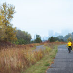 Biking towards Downtown Minneapolis on a autumn morning, a foggy haze covers the tops of the buildings.