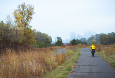 Biking towards Downtown Minneapolis on a autumn morning, a foggy haze covers the tops of the buildings.