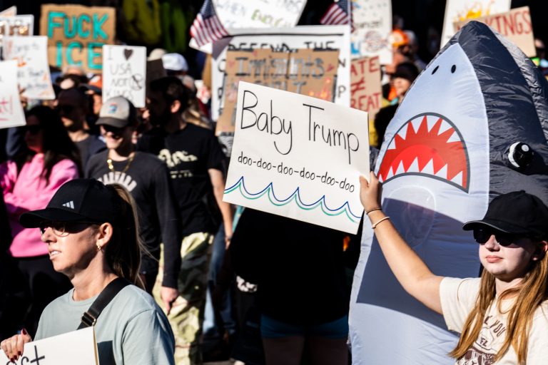 Baby Trump No Kings Minneapolis 2 Protesters in downtown Minneapolis hold anti-Trump signs during a No Kings march on October 18, 2025.