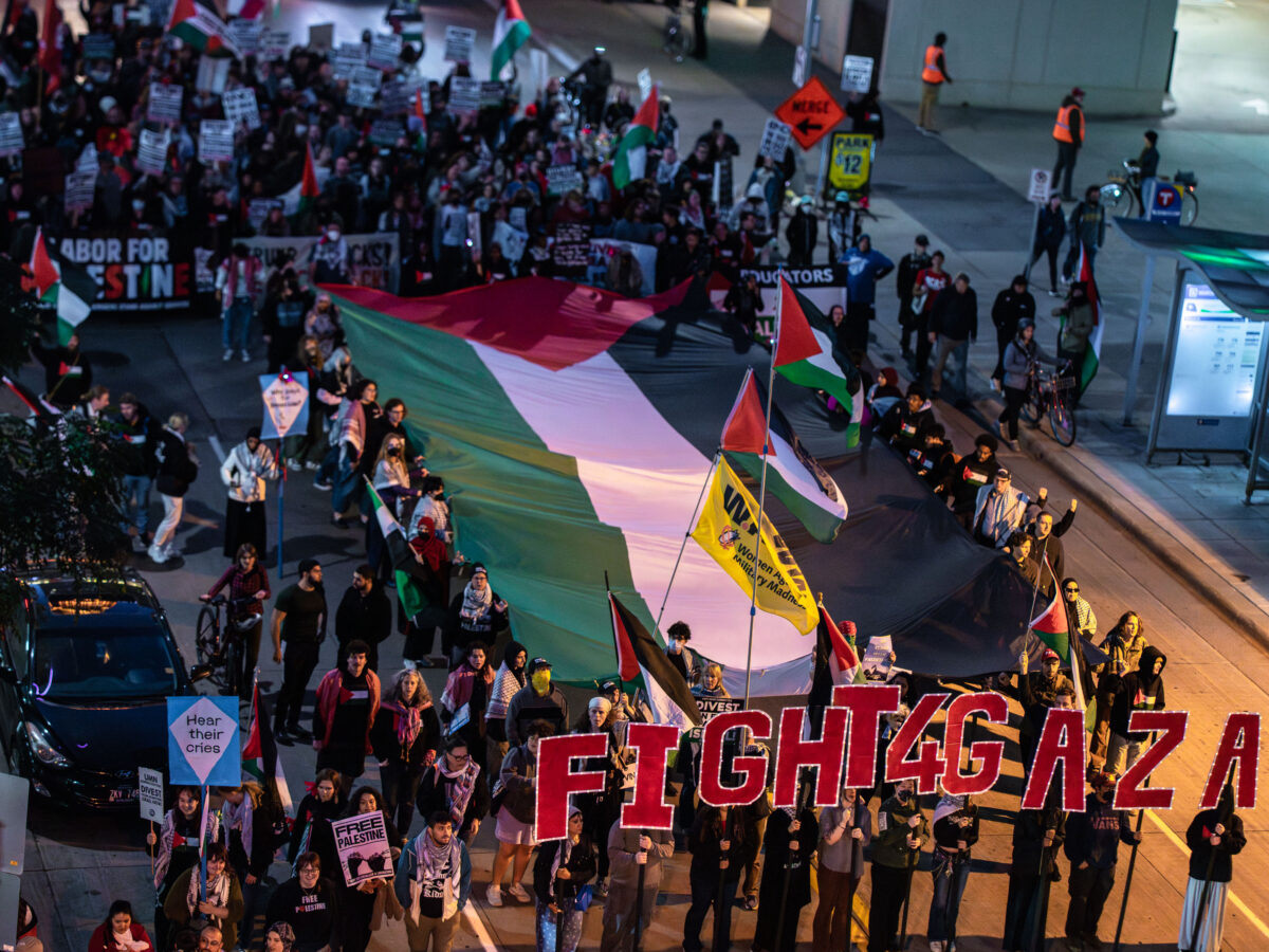 Marchers with a large Palestinian flag in downtown Minneapolis during an October 7, 2025 protest for Gaza.