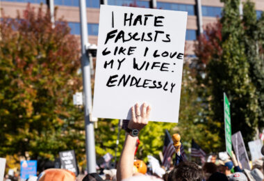 Protester holds up a sign that reads "I hate fascists like I love my wife: Endlessly".

Thousands protest in Downtown Minneapolis on Saturday October 18, 2025 as part of nationwide “No Kings!” protest. Organizers say 100,000 attended.