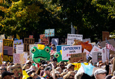 Inflatable frog costume in the crowd of protesters.

Thousands protest in Downtown Minneapolis on Saturday October 18, 2025 as part of nationwide “No Kings!” protest.