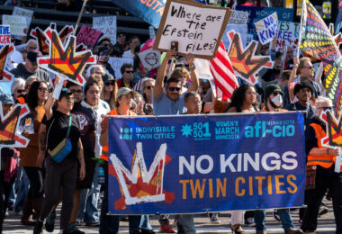Minnesota Attorney General Keith Ellison holding the banner and marching at No Kings in Downtown Minneapolis.

Thousands protest in Downtown Minneapolis on Saturday October 18, 2025 as part of nationwide “No Kings!” protest.