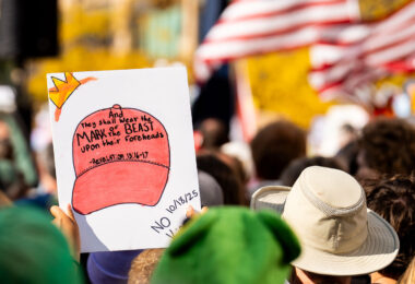 Protester holds up a sign that read "And they shall wear the Mark Of the Beast upon their foreheads".

Thousands protest in Downtown Minneapolis on Saturday October 18, 2025 as part of nationwide “No Kings!” protest.
