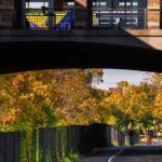 Bikers, walkers on the Midtown Greenway as a bus leaves the Uptown Transit Station above. 

Uptown Minneapolis, October 2025