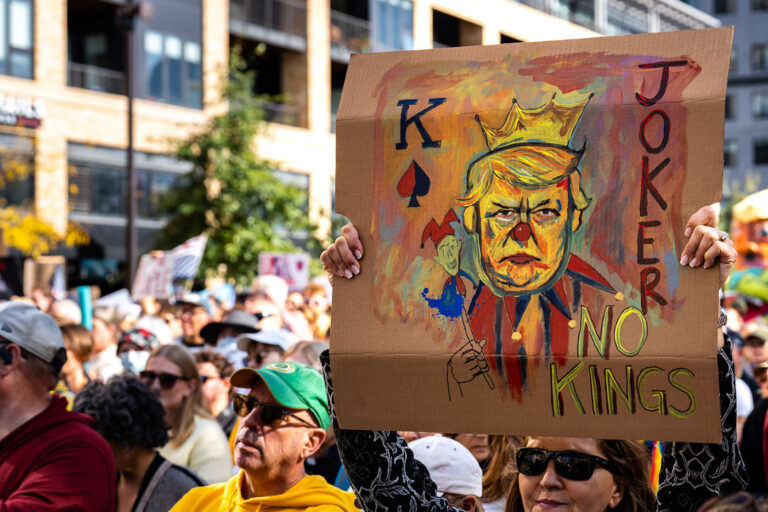 No Kings Artwork in Minneapolis 2 Woman holds up a sign at No Kings Minneapolis.
Thousands protest in Downtown Minneapolis on Saturday October 18, 2025 as part of nationwide “No Kings!” protest. Organizers say 100,000 attended.