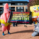 Protesters with Spongebob Squarepants costumes holding a banner thart reads "Science is real, Black Lives Matter, No human is illegal, love is love, women's rights are human rights, kindness is everything."Thousands protest in Downtown Minneapolis on Saturday October 18, 2025 as part of nationwide “No Kings!” protest.