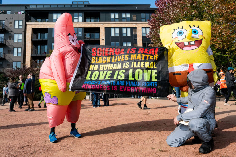 Spongebob Squarepants at No Kings Minneapolis 4 Protesters with Spongebob Squarepants costumes holding a banner thart reads "Science is real, Black Lives Matter, No human is illegal, love is love, women's rights are human rights, kindness is everything."Thousands protest in Downtown Minneapolis on Saturday October 18, 2025 as part of nationwide “No Kings!” protest.