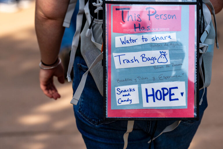 This person has water to share at No Kings 4 Person with a sign that reads "This person has water to share (and other stuff).Thousands protest in Downtown Minneapolis on Saturday October 18, 2025 as part of nationwide “No Kings!” protest.