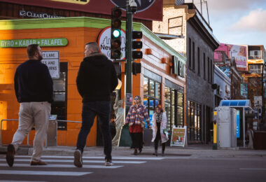 People walking on Lyndale Avenue and Lake Street outside NY Gyro.